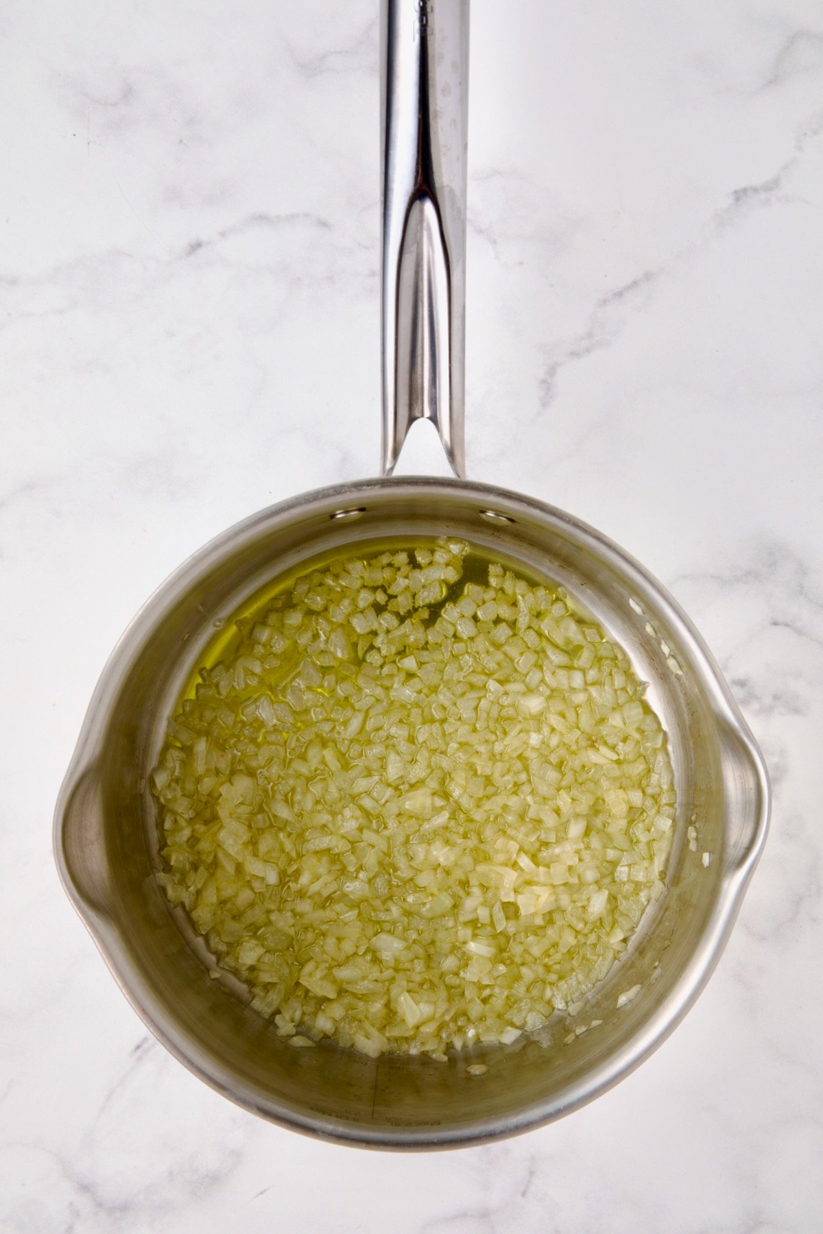 Cooked onion in olive oil in stainless steel saucepan.