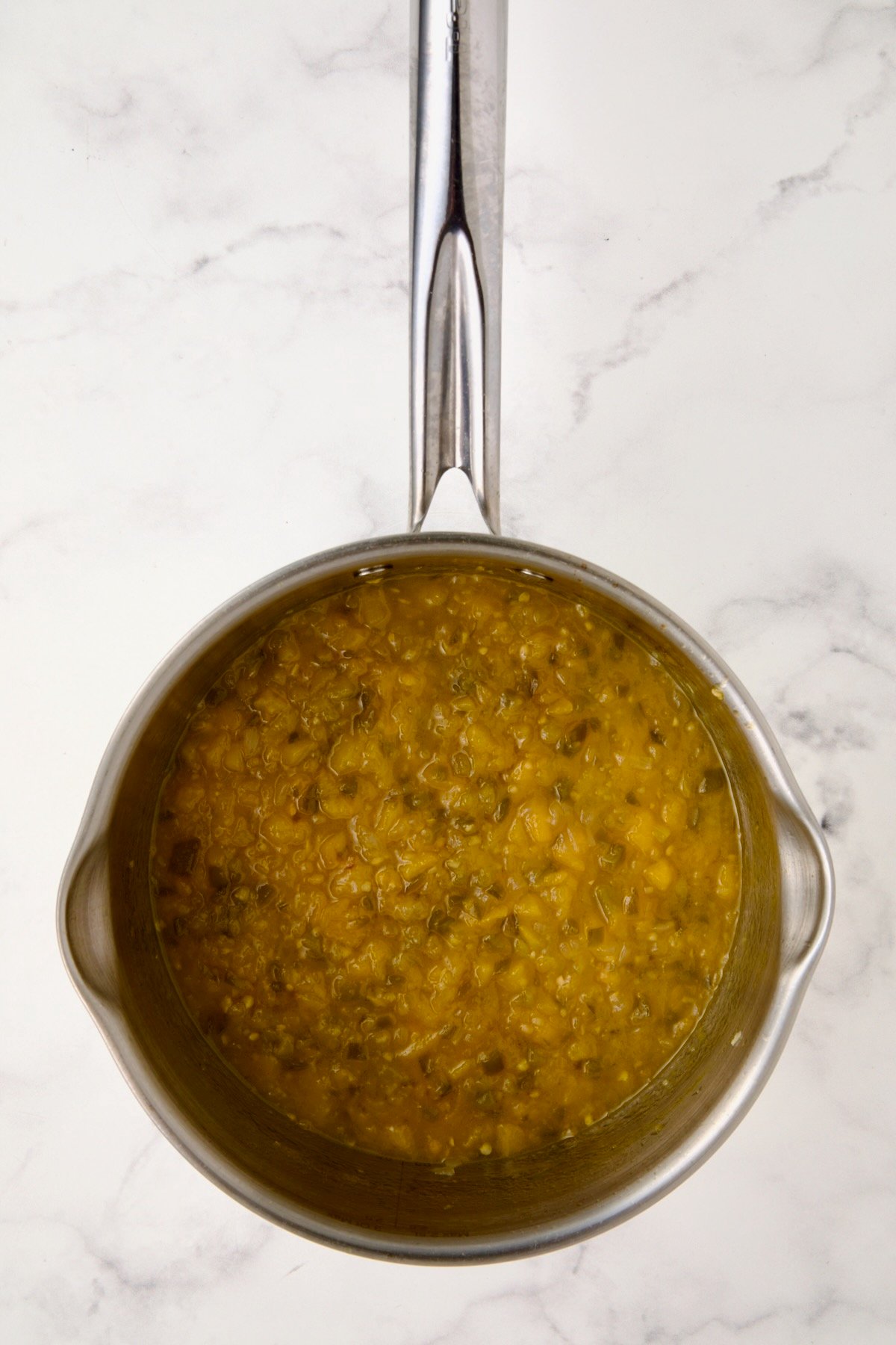 Fully cooked chutney in stainless steel saucepan.