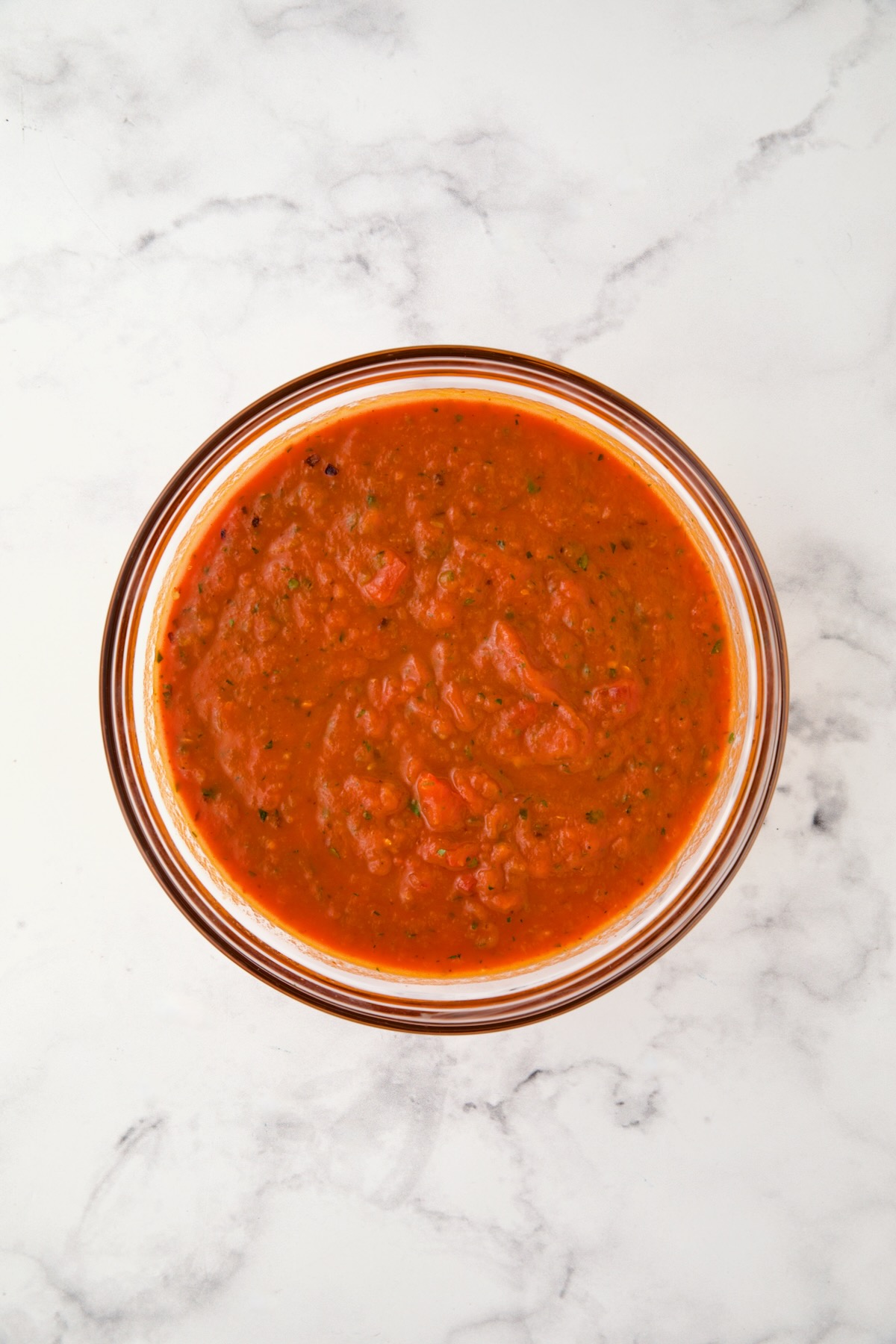Marinara sauce in glass bowl.