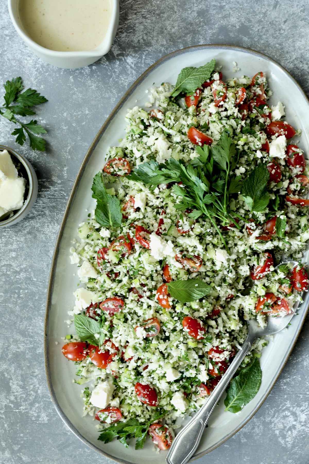 Cauliflower Tabbouleh on platter with serving spoon.