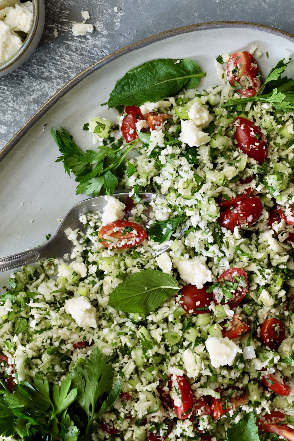 Cauliflower Tabbouleh on platter with serving spoon.