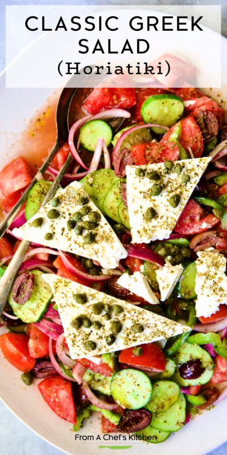 Pinterest graphic for Classic Greek Salad showing it on an oval white platter.