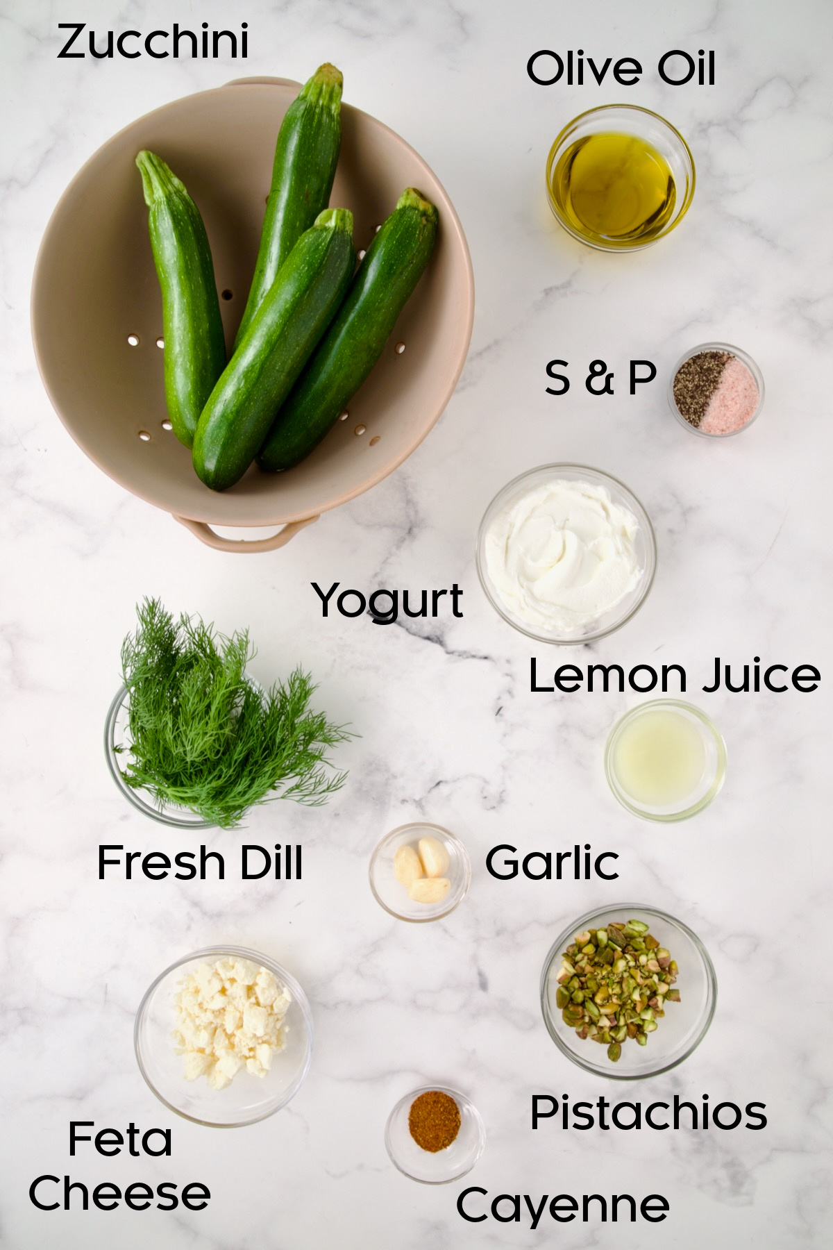 Ingredients for Mediterranean Grilled Zucchini with Dill Yogurt and Feta in glass bowls.