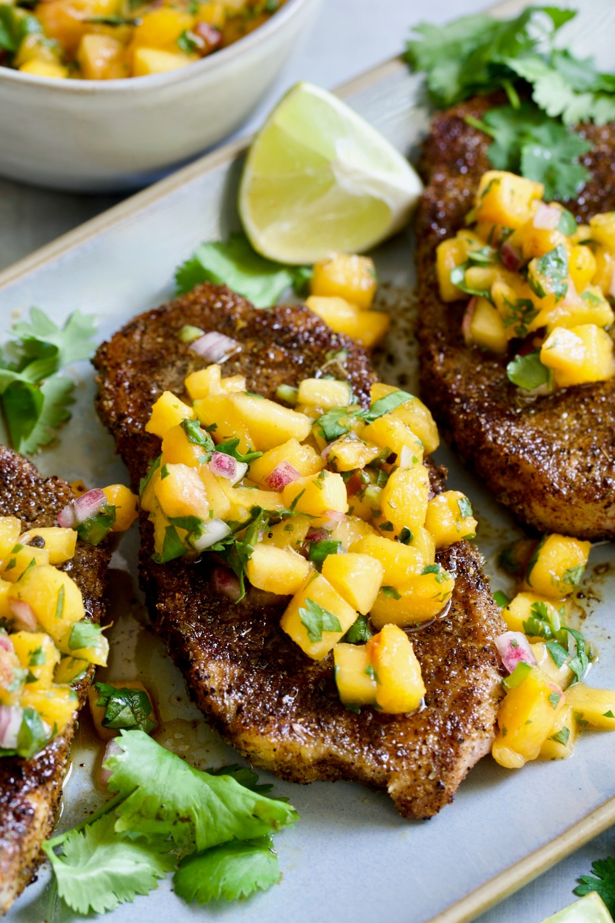 Pork Chops with Peach Salsa on oval gray platter.