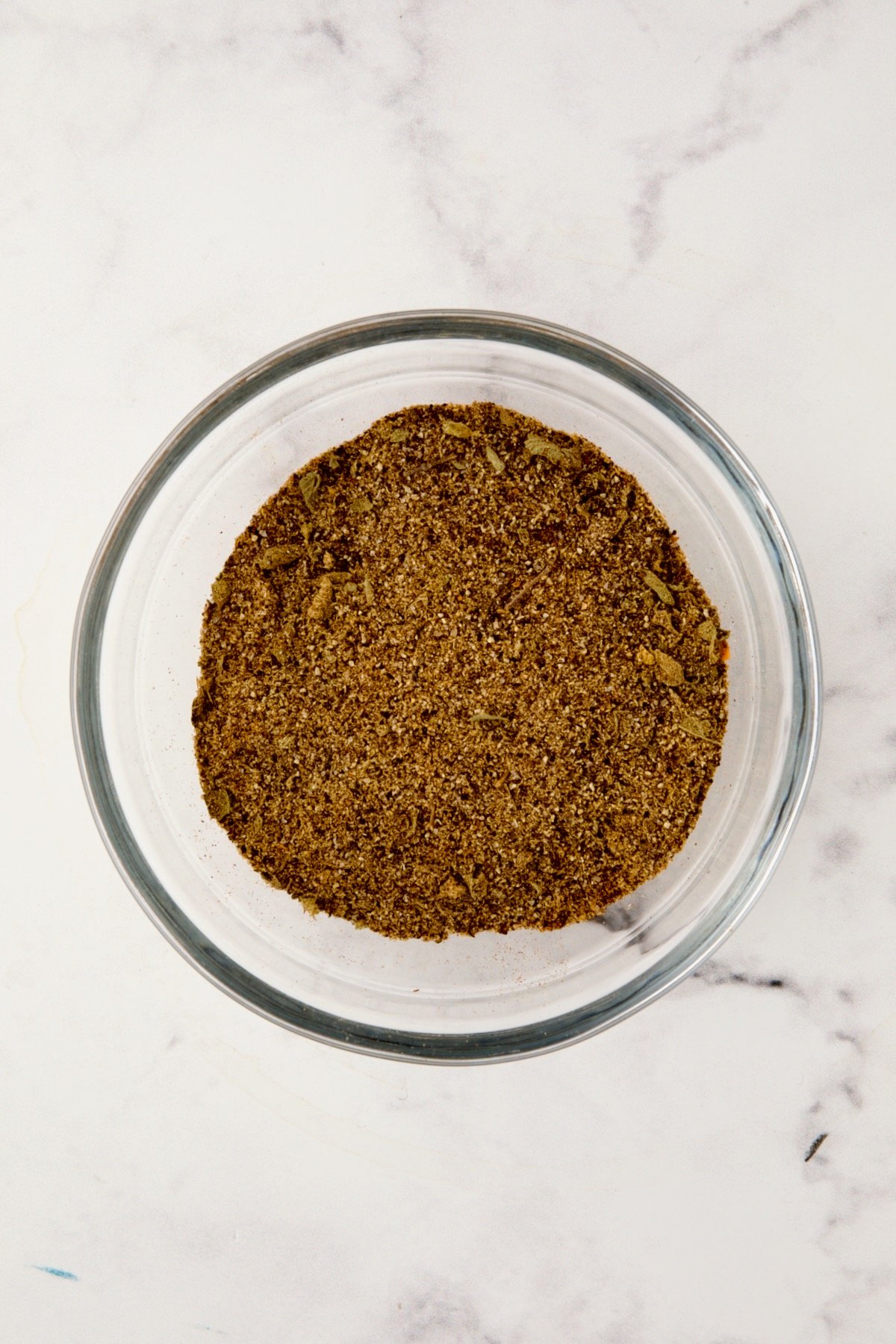 Spices for spice rub in glass bowl after being stirred together.