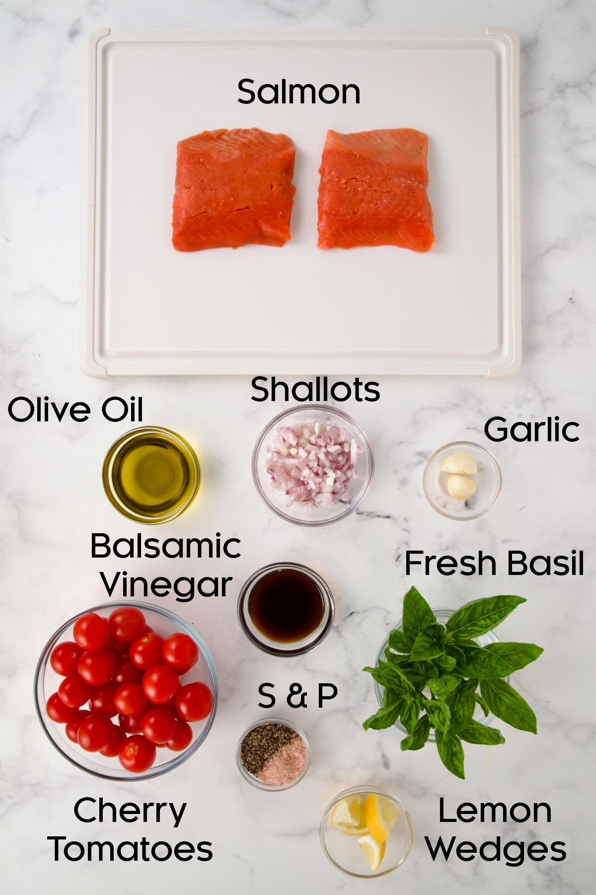 Ingredients for Salmon with Balsamic Cherry Tomatoes in glass bowls with the salmon on a white plastic cutting board.