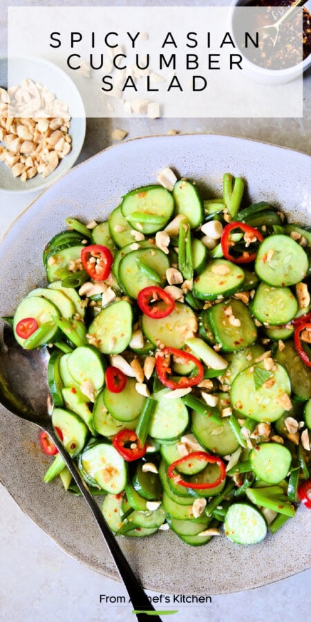 Pinterest graphic for Spicy Asian Cucumber Salad showing it in an earthenware bowl with serving spoon.