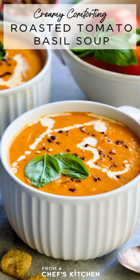 Pinterest graphic for Creamy Tomato and Basil Soup showing it in a white soup mug garnished with fresh basil, cream and red pepper flakes.