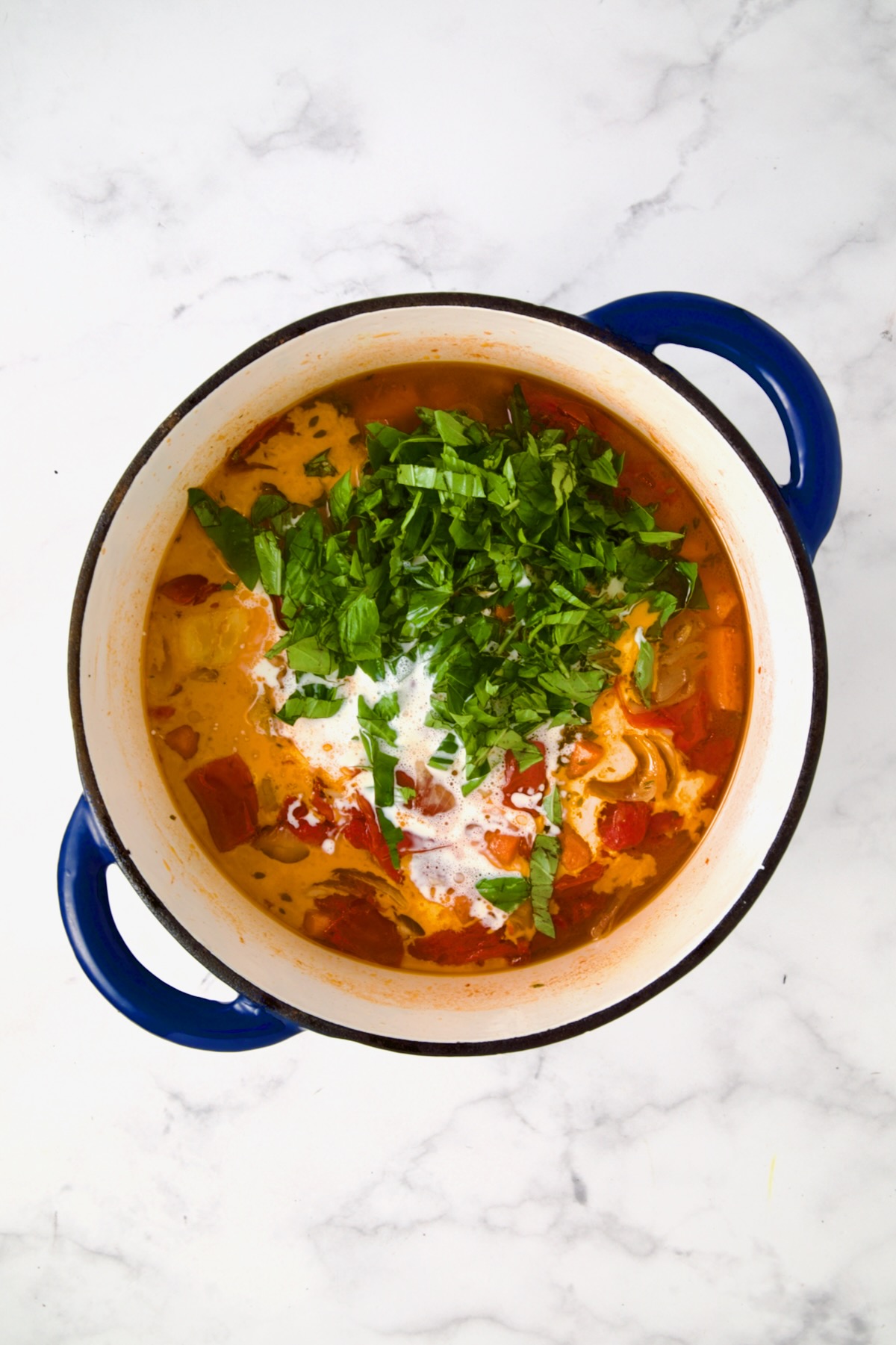 Tomato soup after cream and fresh basil added.