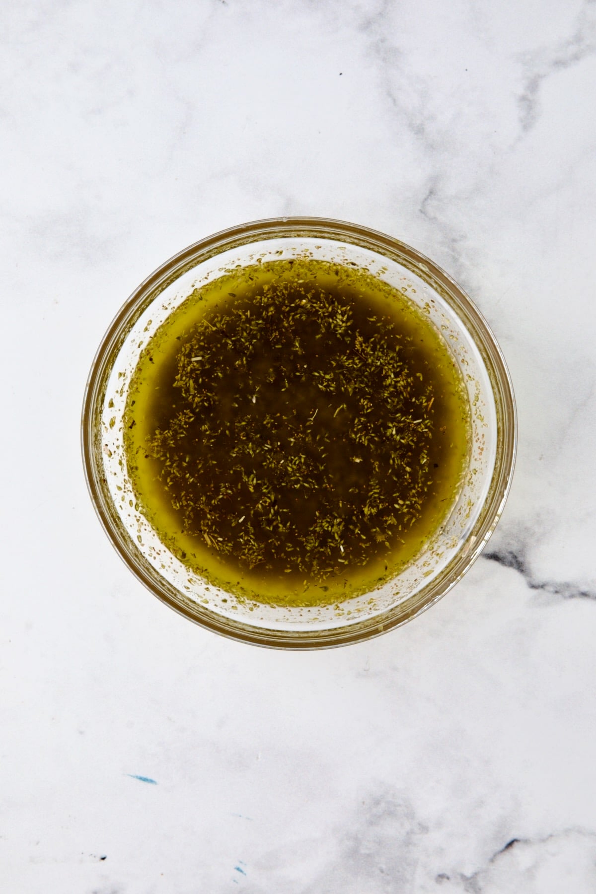 Marinade for Greek Roast Chicken in glass bowl.