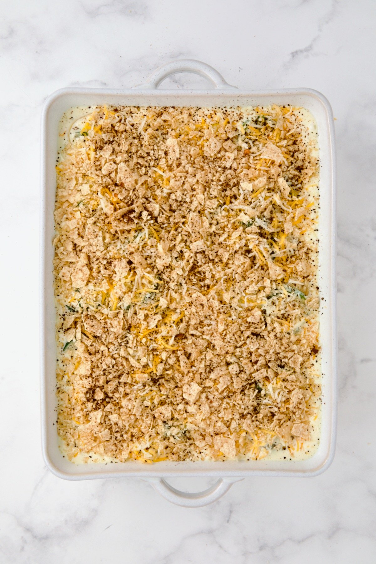 Summer Squash Corn Poblano Casserole with tortilla chip topping and chili powder added.