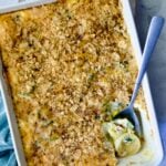 Summer Squash Corn Poblano Casserole in rectangular white baking dish with serving spoon.