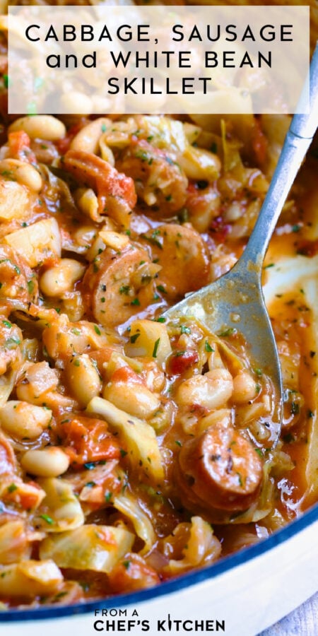 Pinterest graphic for Cabbage, Sausage and White Bean Skillet showing it in a white enamel cast iron skillet with serving spoon.