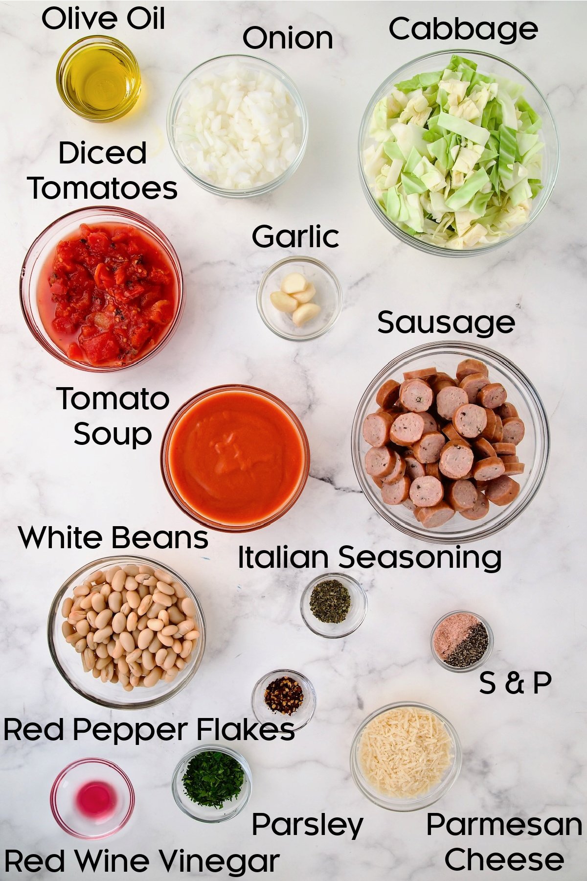 Ingredients for Cabbage Sausage White Bean Skillet in glass bowls.