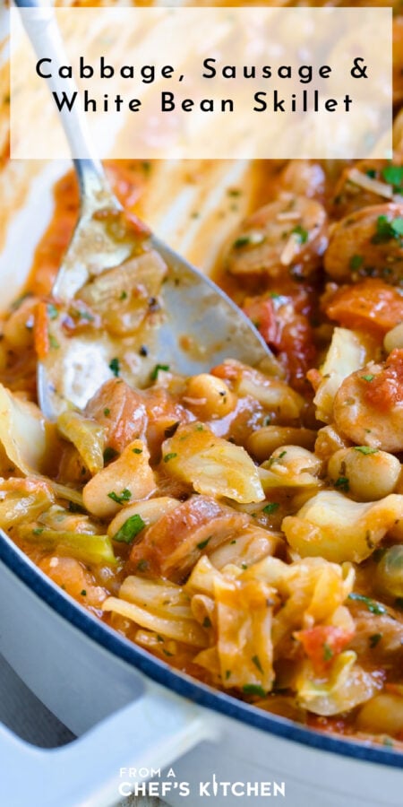 Pinterest graphic for Cabbage, Sausage and White Bean Skillet showing it in a white enamel cast iron skillet with serving spoon.