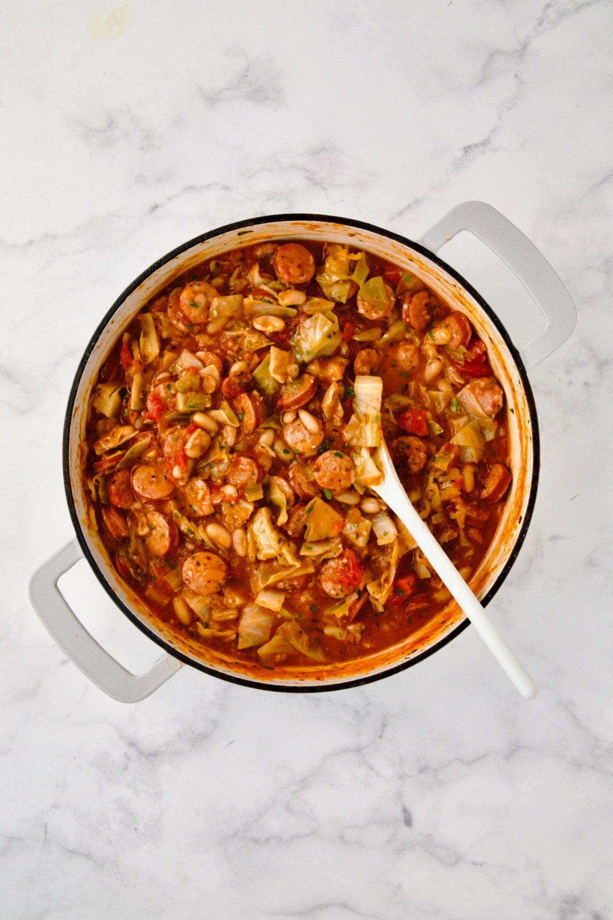 Finished dish in white enamel cast iron skillet.