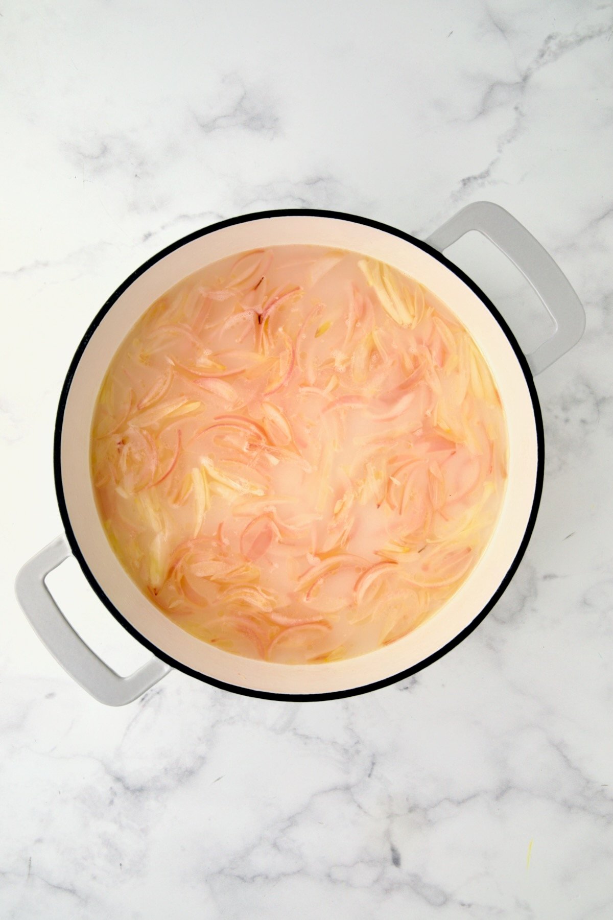 Water, vinegar and sugar added to cooked shallots in white enamel cast iron skillet.