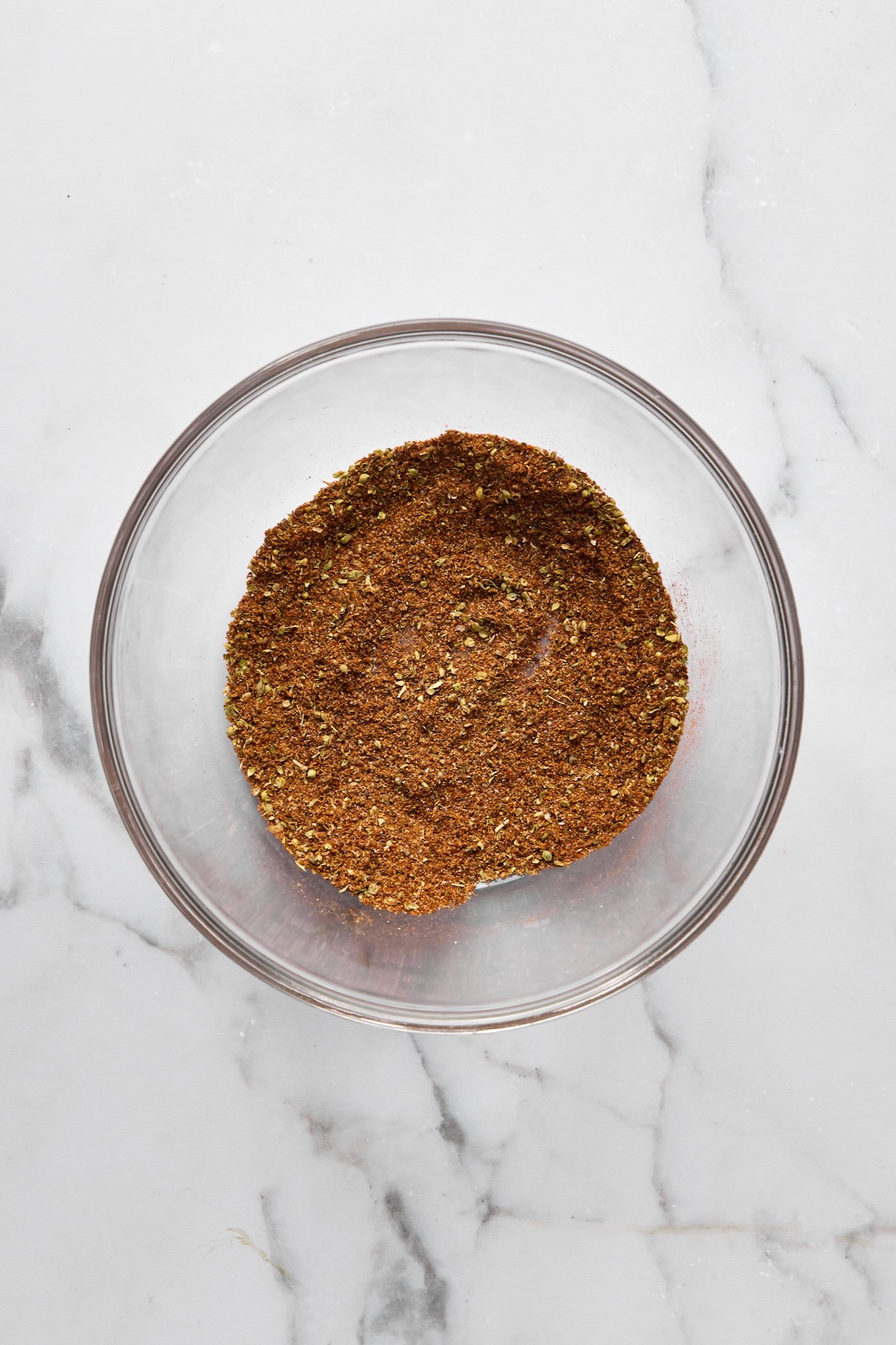 Spices in glass bowl mixed together.