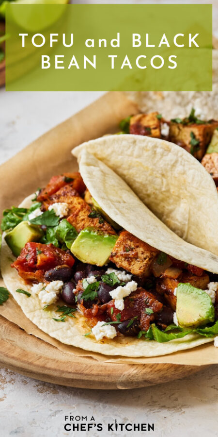 Pinterest graphic for Tofu and Black Bean Tacos showing one on a parchment paper-lined wooden tray.