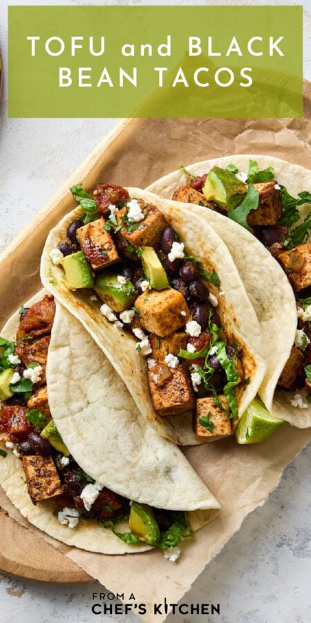 Pinterest graphic for Tofu and Black Bean Tacos showing three on a parchment paper-lined wooden tray.