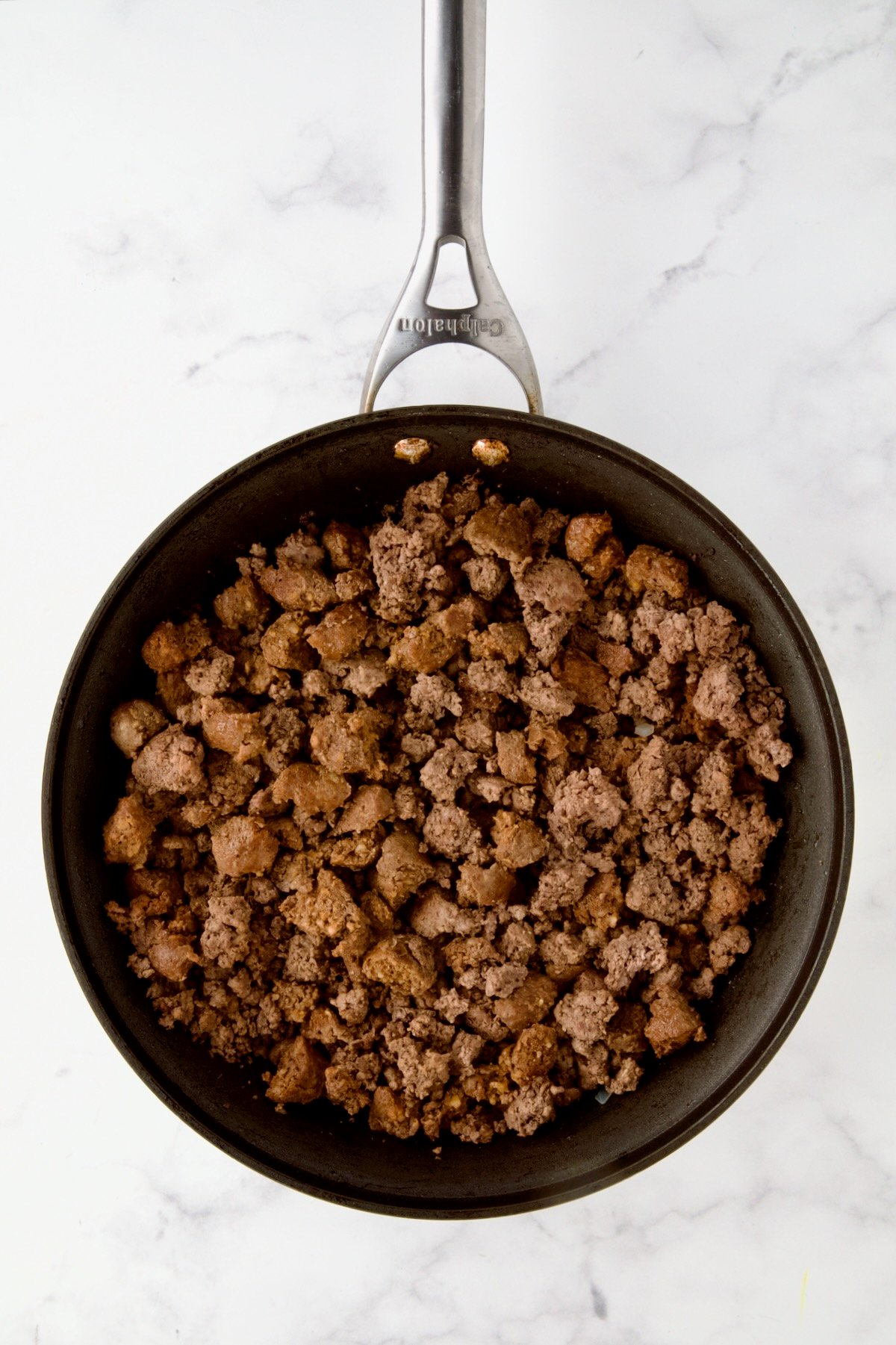 Browned ground beef and pork in nonstick skillet.