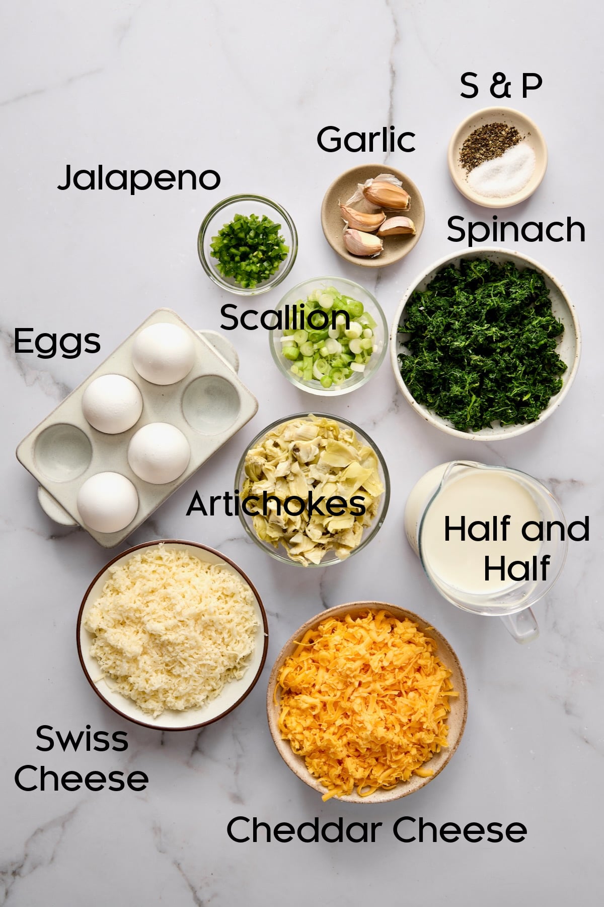 Ingredients for Crustless Spinach Artichoke Quiche in glass bowls.