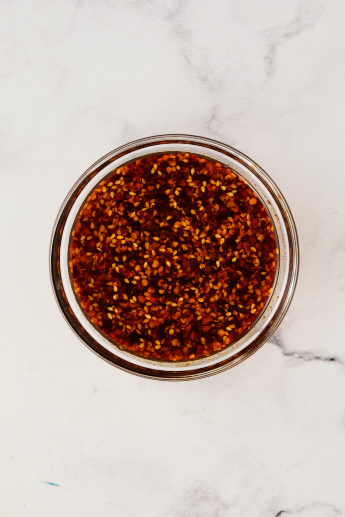 Sauce for Maple Chili Crisp Brussels Sprouts and Butternut Squash in glass bowl.