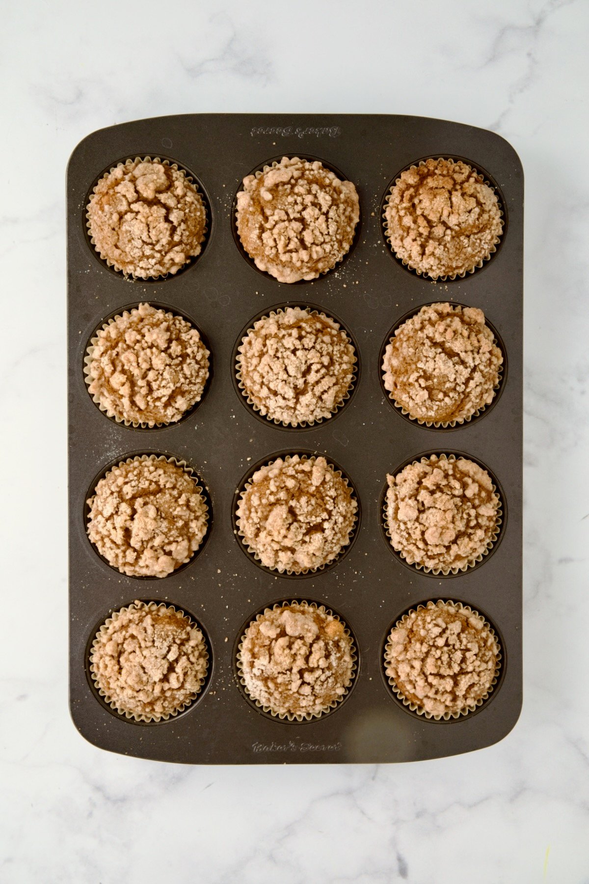 Baked Pumpkin Streusel Muffins in 12-cup muffin pan.