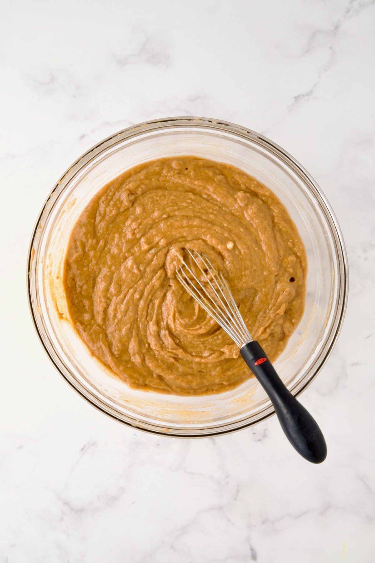 Batter for muffins in glass bowl.