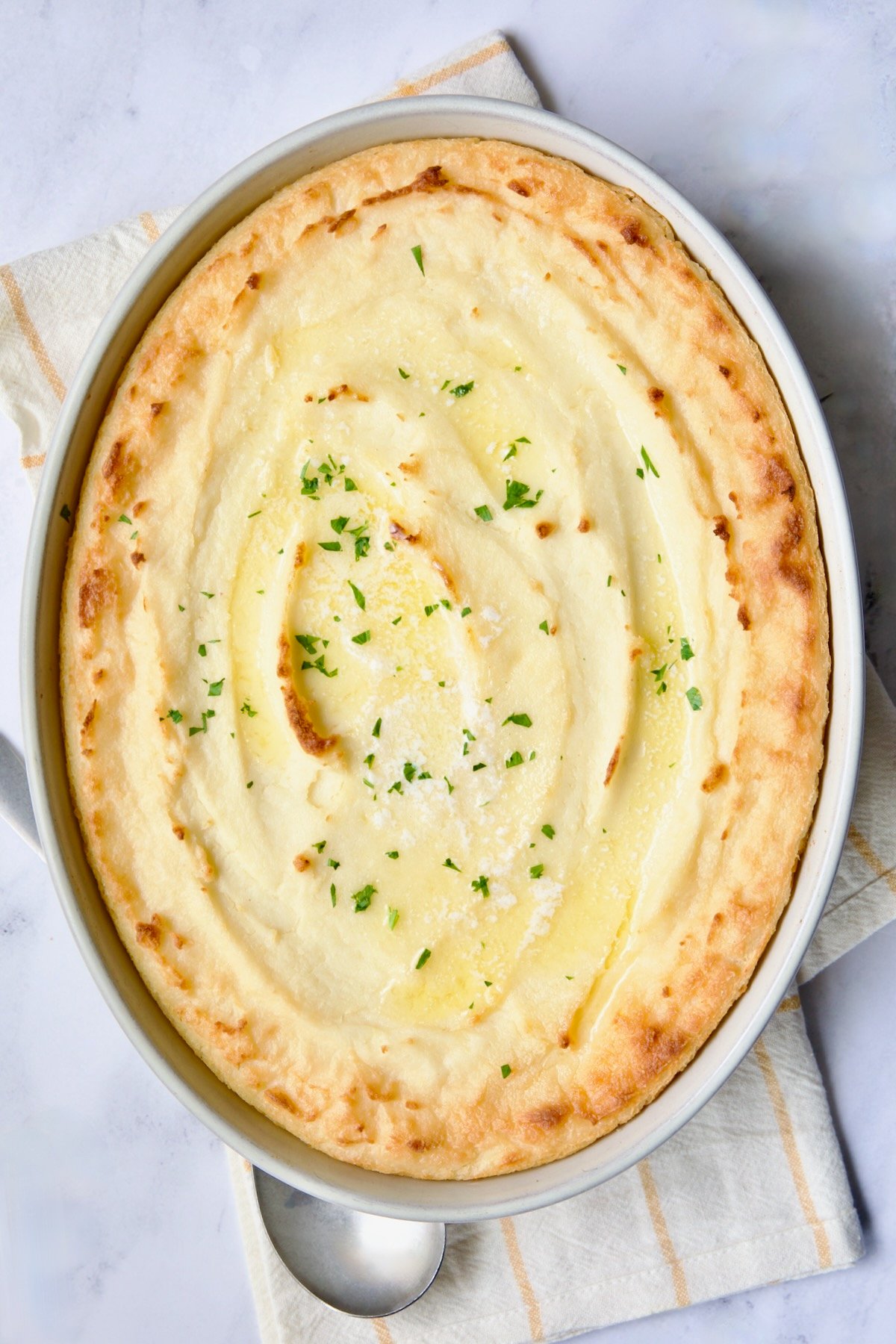 Twice-Baked Mashed Potatoes in white oval baking dish.