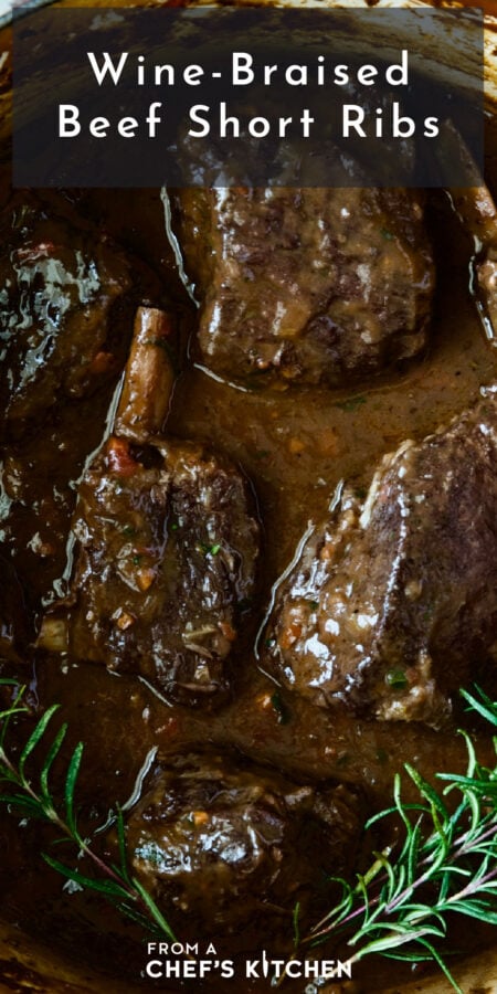 Pinterest graphic for Wine-Braised Beef Short Ribs showing them in a Dutch oven with fresh rosemary sprigs.