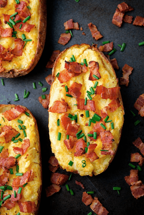 Twice-Baked Potatoes with Cheddar and Bacon on a baking sheet.