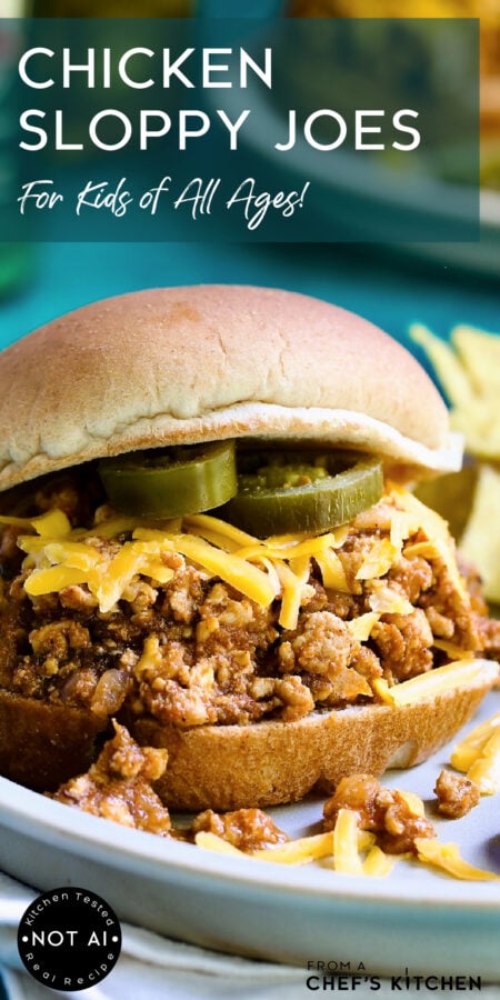 Pinterest graphic for Chicken Sloppy Joes showing one serving on a plate garnished with shredded cheese and jalapeno cheese slices.
