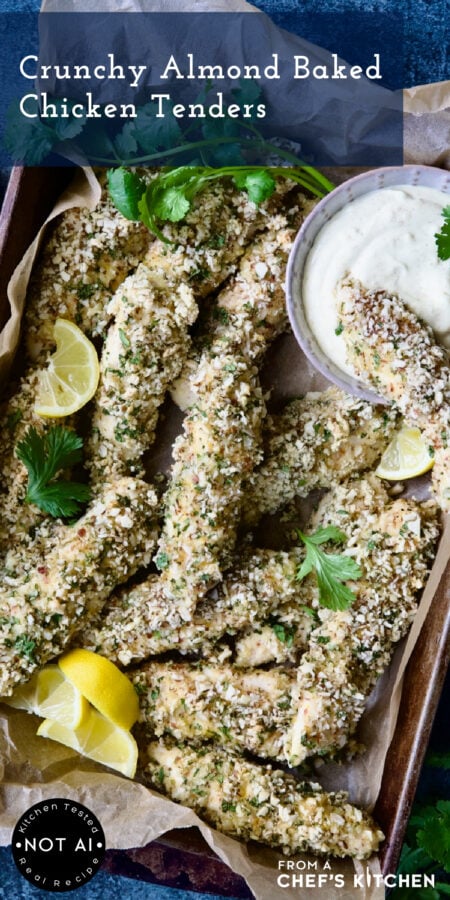 Pinterest graphic for Crunchy Almond Baked Chicken Tenders showing them in a metal parchment paper lined pan.
