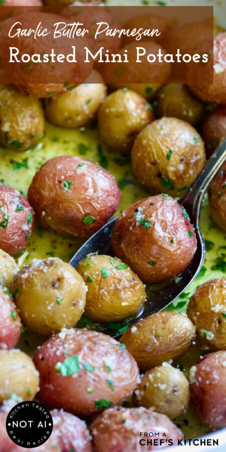 Pinterest graphic for Garlic Butter Parmesan Mini Potatoes showing them in a white baking dish with two being scooped up on a serving spoon.