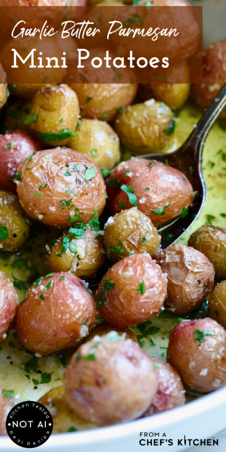 Pinterest graphic for Garlic Butter Parmesan Mini Potatoes showing them in a white baking dish with three being scooped up on a serving spoon.