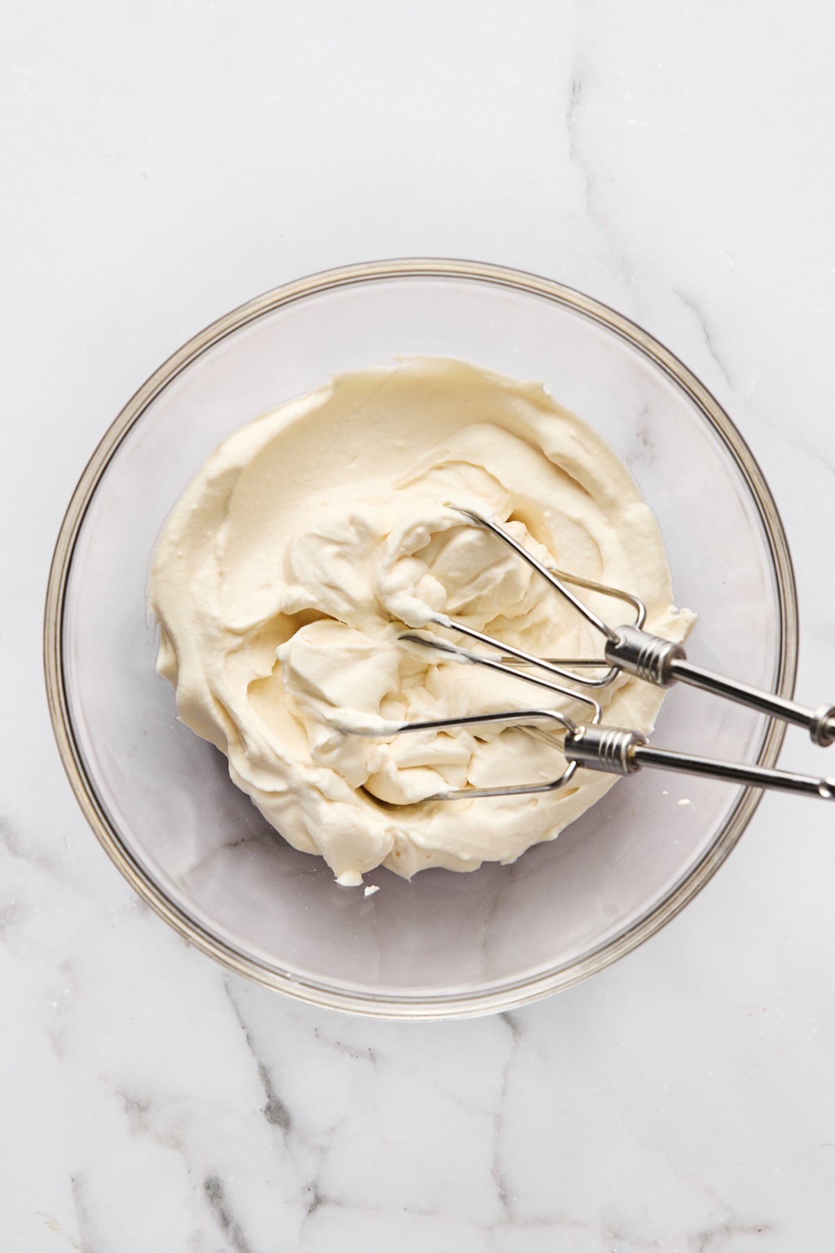 Mascarpone whipped cream in glass bowl.