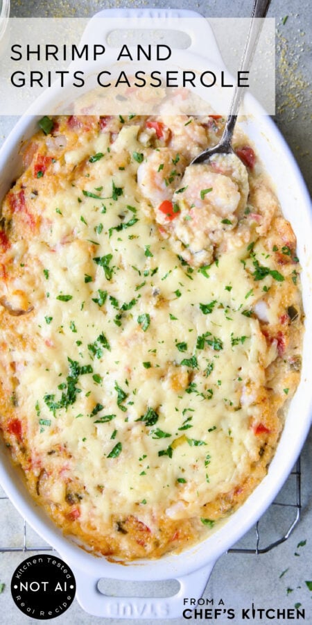 Pinterest graphic for Shrimp and Grits Casserole showing it in an oval white baking dish with serving spoon scooping up some shrimp.