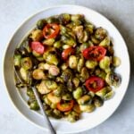Hot Honey Brussels Sprouts in white serving bowl with serving spoon.