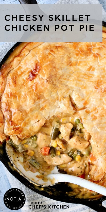 Pinterest graphic for Cheesy Skillet Chicken Pot Pie showing it in a black cast iron skillet with white serving spoon.
