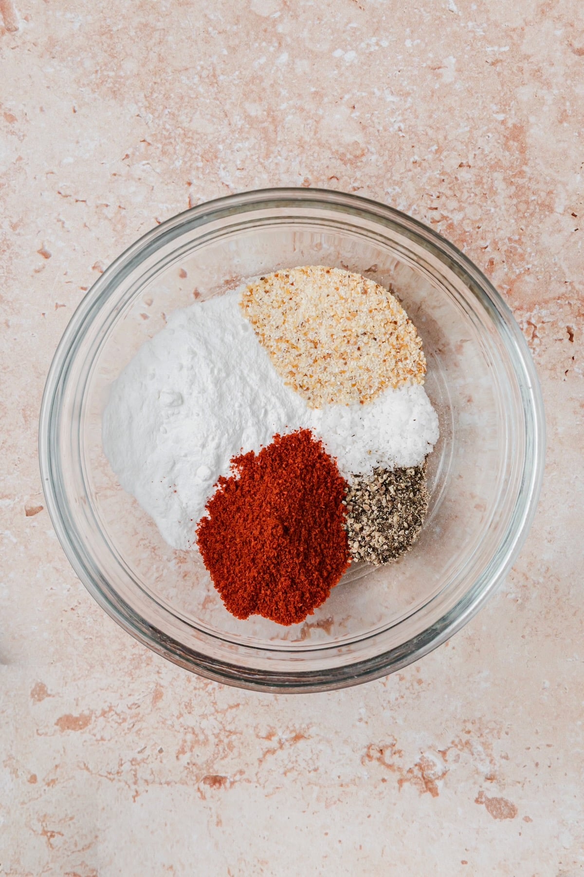 Ingredients for Hot Honey Chicken Wings rub in glass bowl before being combined.
