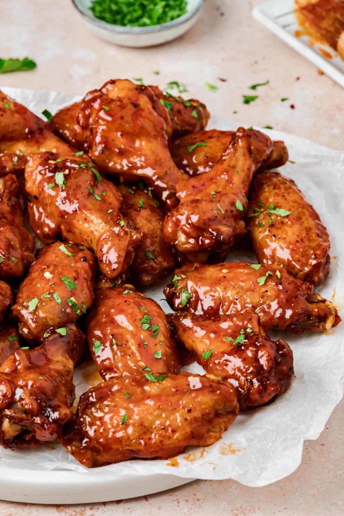 Hot Honey Chicken Wings on parchment paper lined platter.