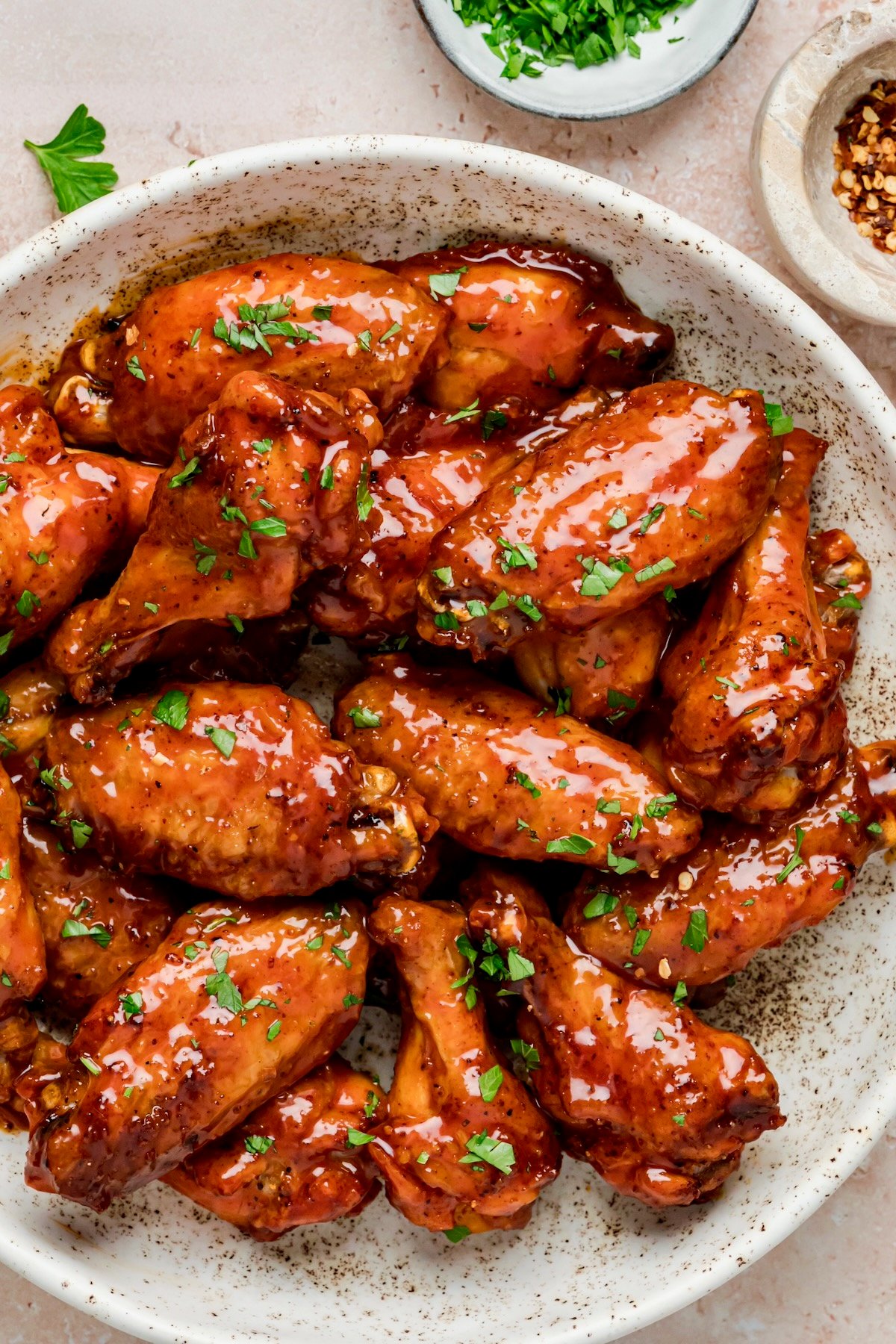 Glazed Hot Honey Chicken Wings in speckled bowl.