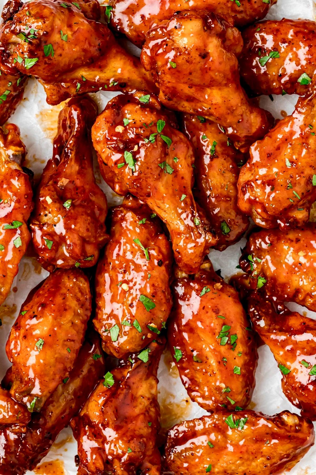 Hot Honey Chicken Wing garnished with chopped parsley.