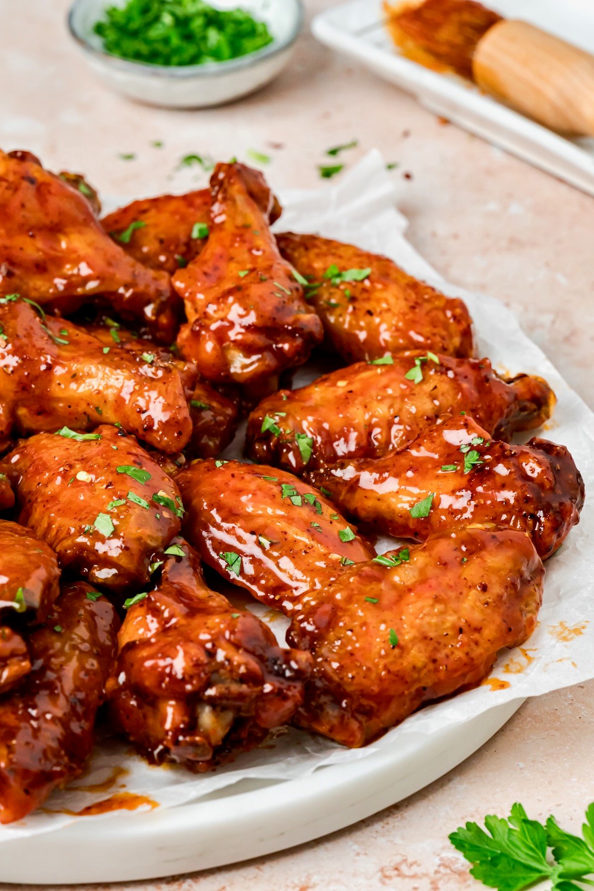 Hot Honey Chicken Wings on parchment paper lined platter.