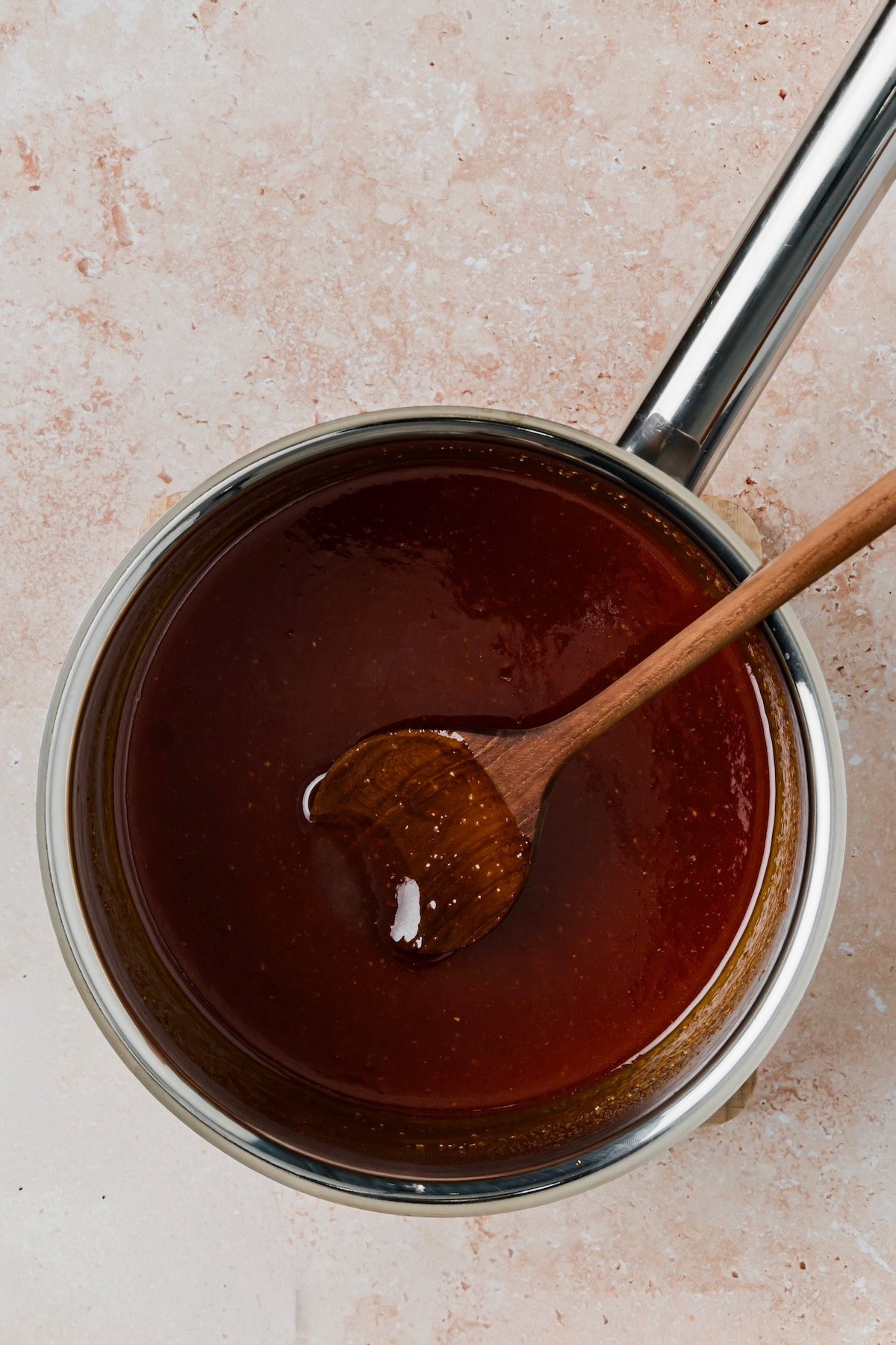 Sauce ingredients in stainless steel saucepan after being cooked.