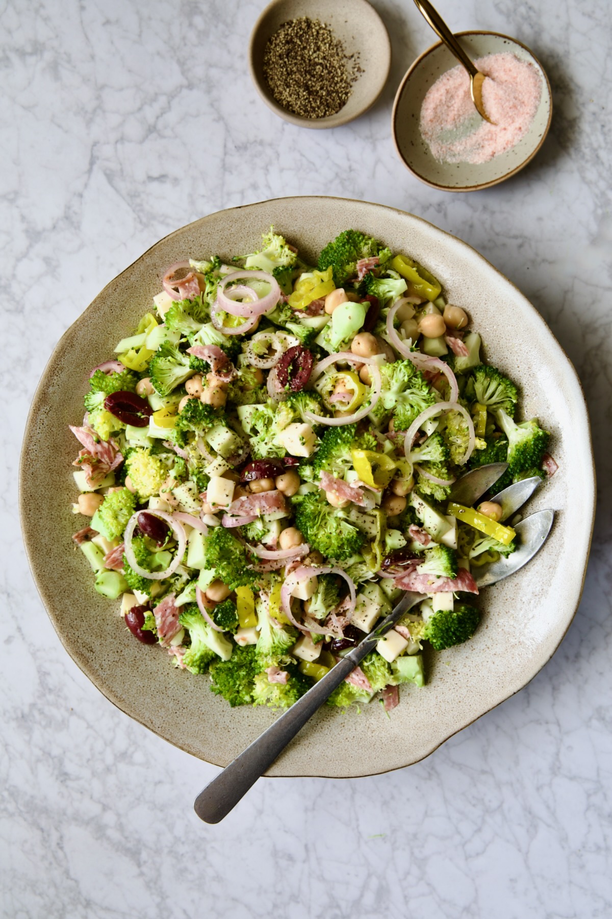Italian Broccoli Salad in earthenware bowl with serving fork.