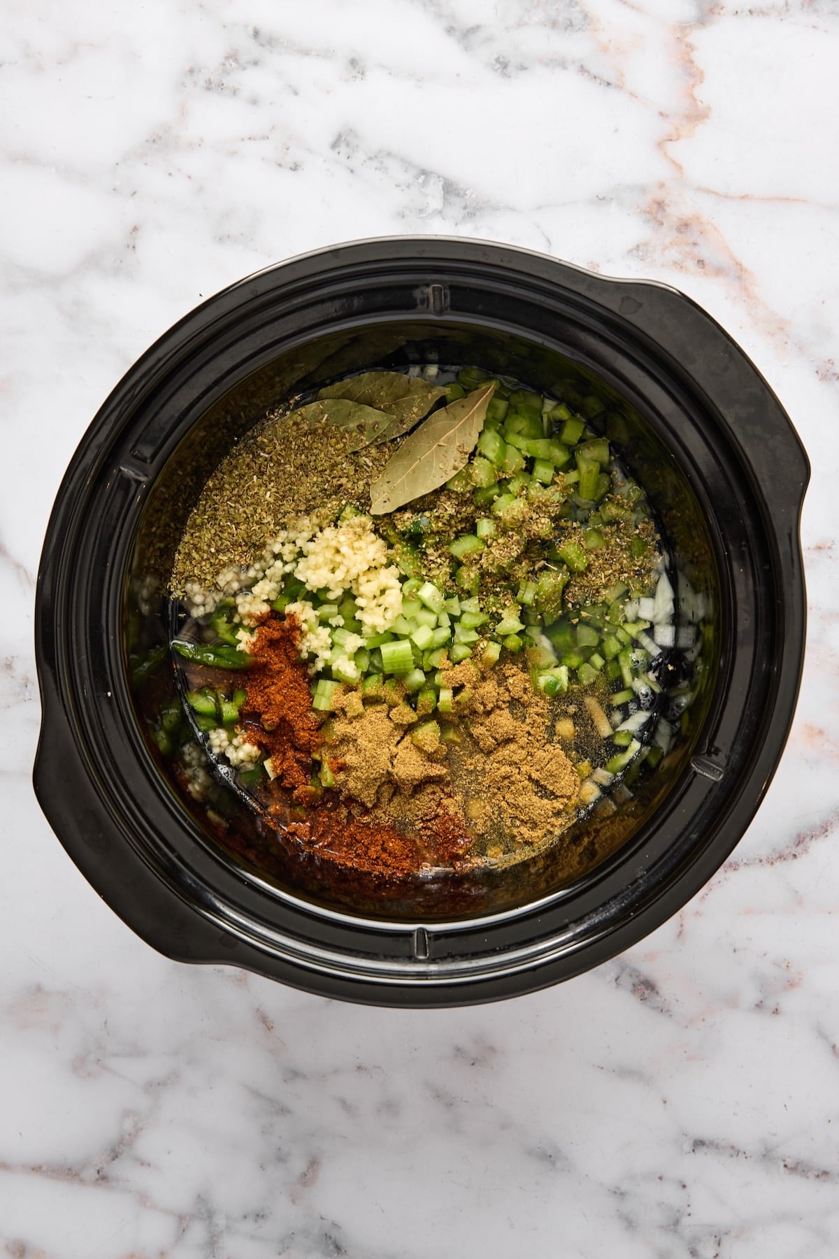 Ingredients for Slow Cooker Black Bean Soup in slow cooker before being stirred together.