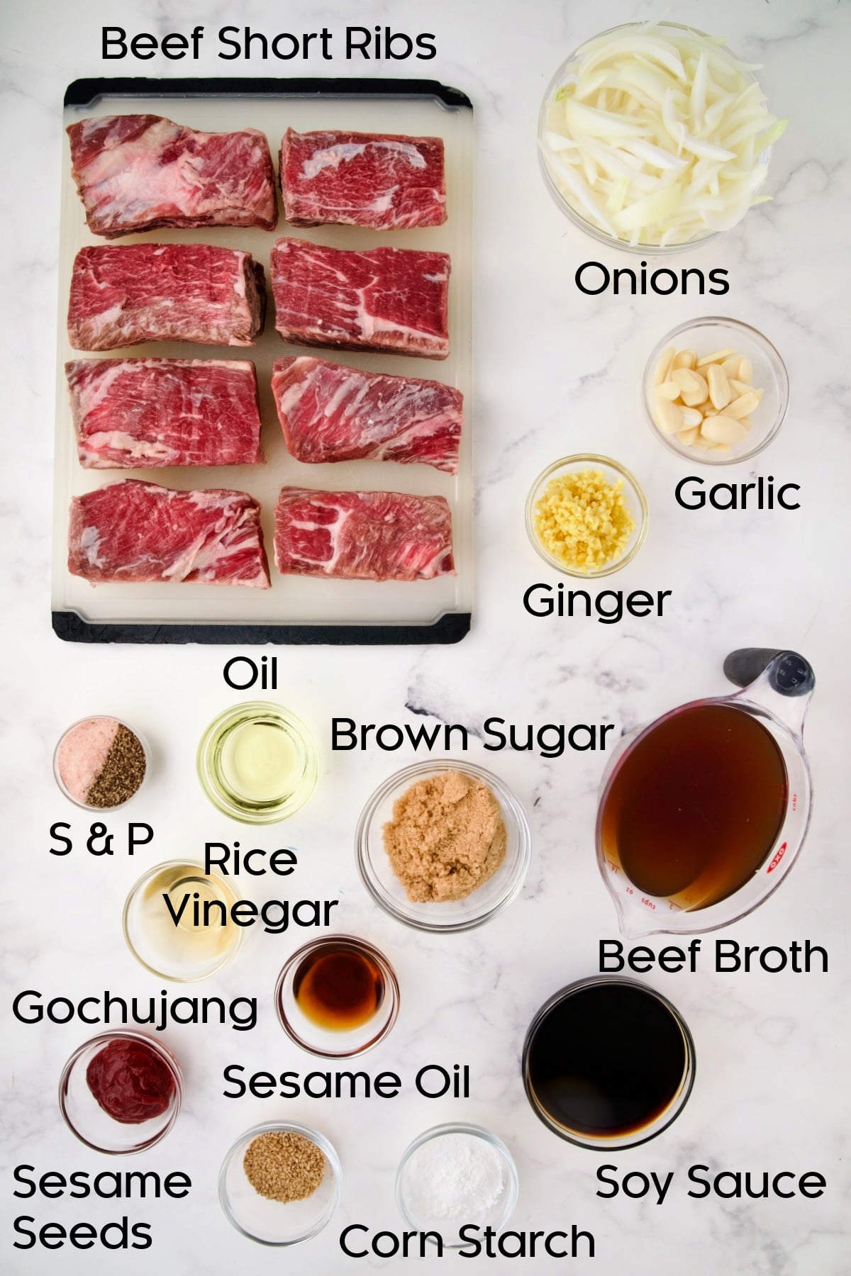 Ingredients for Korean Braised Beef Short Ribs in glass bowls with ribs on white plastic cutting board.