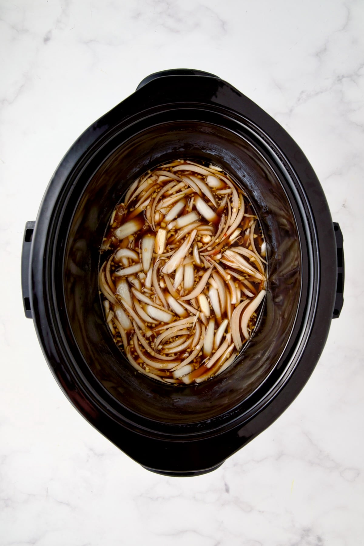 Ingredients for short ribs in slow cooker before ribs are placed inside.